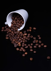 cup of coffee with beans on black background