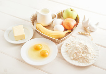 pie with banana, apples and nectarine on a white wooden background