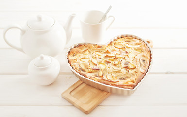 pie with banana, apples and nectarine on a white wooden background