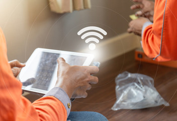 Internet technician man checking speedtest upload and download with tablet, Home IT network concept