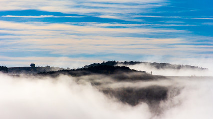 cloudscape with mountains and mist fog