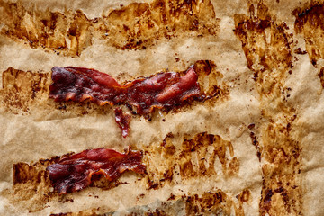 Top view of bacon baked on parchment