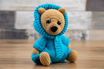 Obraz premium Funny knitted toy bear. Amigurumi toy. Crochet stuffed animals.
