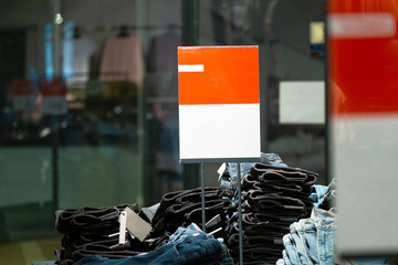 signs with mockup in a clothing store. light industry in clothing stores. sign with white and red background