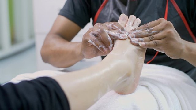 Shot of a girl / women getting a foot massage and pedicure in the beauty salon. 