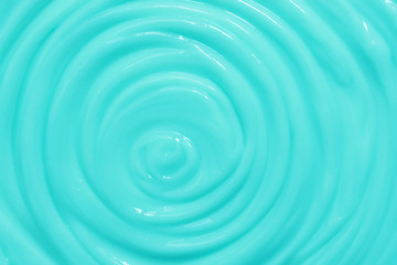 Gently turquoise moisturizer texture. Cosmetic cream background in a beautiful blue color.