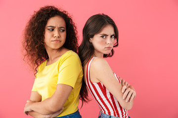 Image of confused multinational girls having quarrel and standing back to back