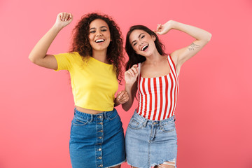 Image of happy multinational girls smiling and dancing together