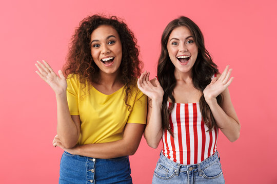 Image of beautiful multinational girls smiling together and waving at camera