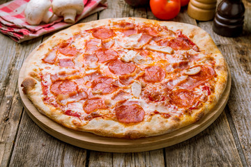 Italian meat pizza on wooden table