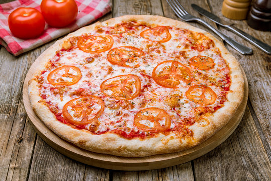 Italian pizza Margherita on wooden table