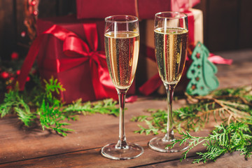 champagne and new year or christmas (champagne glass, sparkling wine and gifts on the table) menu concept. food background. copy space. Top view