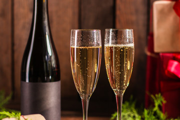 champagne and new year or christmas (champagne glass, sparkling wine and gifts on the table) menu concept. food background. copy space. Top view