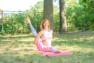 Young girl doing yoga in the forest on a sunny day