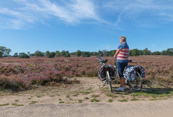 woman with e bike on the dutch heather fields
