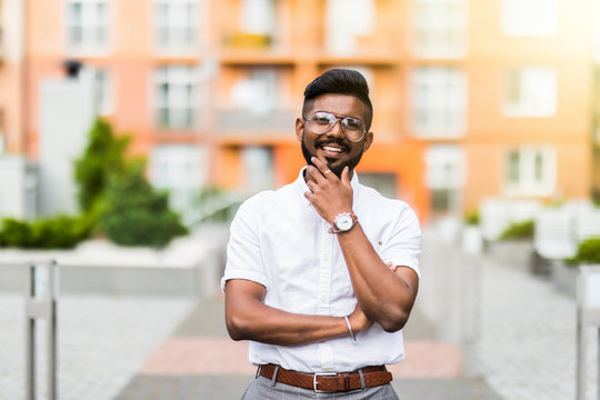 Asian business man crossing arm in the street. Portrait of Asian, north indian successful and confident businessman