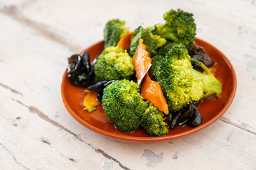 Mixture of vegetables cooked with broccoli and black mushrooms served in a plate for eating