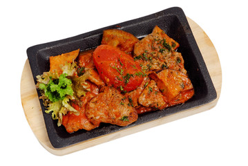 Baked vegetables potato, zucchini, eggplant on plate. Vegetarian food on the pan on a white isolated background