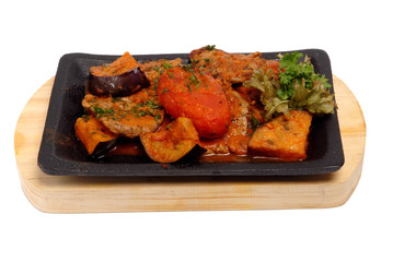 Baked vegetables potato, zucchini, eggplant on plate. Vegetarian food on the pan on a white isolated background