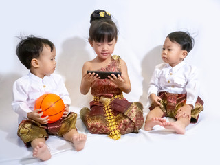 Two Thai little boy and girl in traditional Thai costume in white background