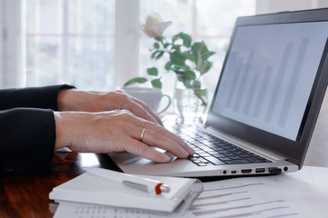 business woman is working on a laptop in the office to calculate finances and  taxes