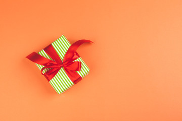 Present with a bow on orange background