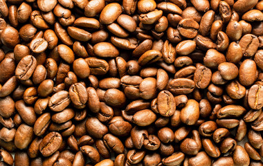 Coffee beans background image. Top view of roasted coffee beans, macro shot.