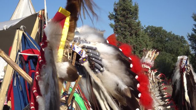 Native American Indian Headdresses and Clothing. Navajo Leather Shield with Feathers.  Bow and arrows