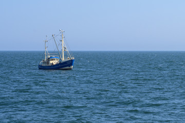 fishing boat on the north sea under the blue sky, copy space