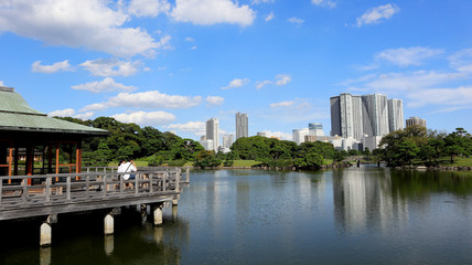 Fototapeta na wymiar TOKYO, JAPAN. 2019 Sep 26th. View of Hamarikyu Japanese Garden and High-Rise Buildings.