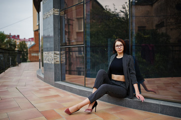 A tall leggy young beautiful and elegant model woman. Business woman at eyeglasses.