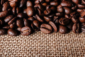 Coffee beans on burlap background