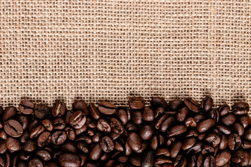 Coffee beans on burlap background