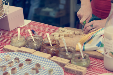 Close up of hands slicing bread for tasting at outdoor market place.