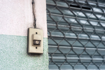 Doorbell or buzzer on mounted on wall