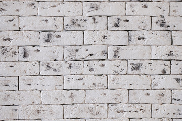 the texture of a white brick wall of large artificially aged bricks