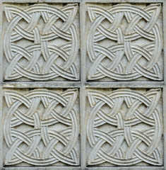 Christian pattern carved in stone on the wall of an old Christian church in Georgia