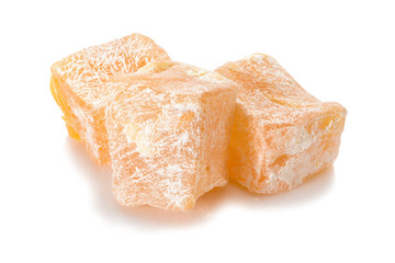 Turkish delight. Pistachio rahat locum with nuts, three pieces of sweet oriental delights in powered sugar. Close-up view.