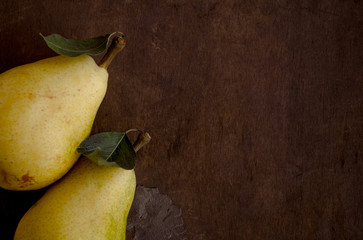 Composition with two pears on wood texture with place for a text.