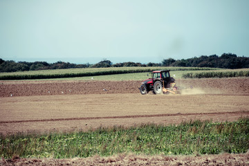 nice view of a farmer plowing his fields