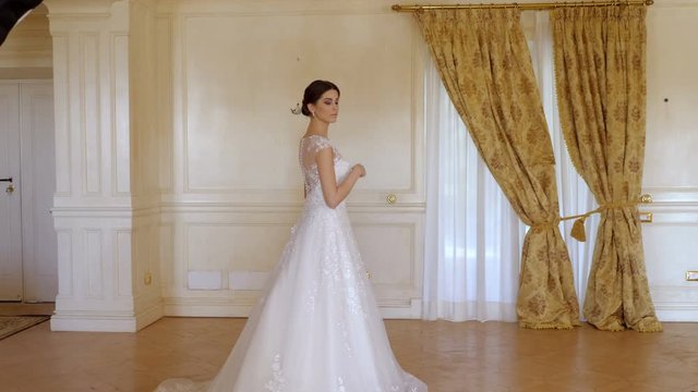 photographer taking photos of classy beautiful woman in a wedding dress
