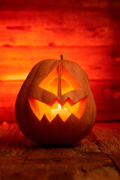 Halloween - old jack-o-lantern on wooden background