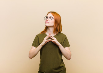 young red head pretty woman scheming and conspiring, thinking devious tricks and cheats, cunning...