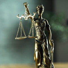 Fototapeta premium Law and Justice concept. Mallet of the judge, books, scales of justice. Gray stone background, reflections on the floor, place for typography. Courtroom theme.