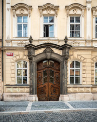 Fototapeta na wymiar Prague Town House. An ornate wooden door and elaborate entrance to a typical townhouse in the Old Town district of central Prague, Czech Republic.