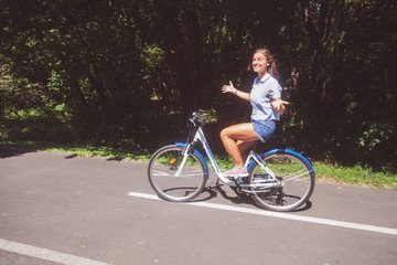  Young Woman Riding Bicycle In The Park