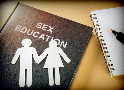 Book of sexual education next to a notebook, conceptual image