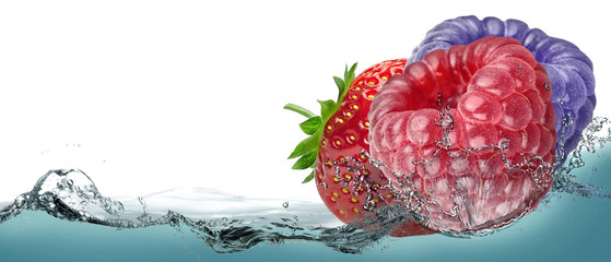 Strawberries, raspberries, blackberries in a spray of lemonade.