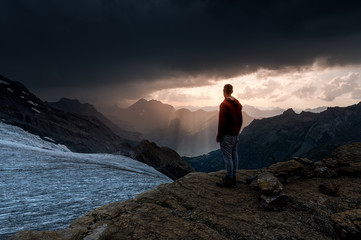 Fototapeta premium silhouette of a man standing in front of Blümlisalpgletscher at Blümlisalphütte SAC
