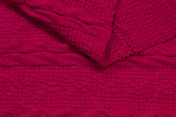 The fabric is a waffle knit red. The texture of the knitted fabric